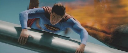 Superman lands on the plane's wing
